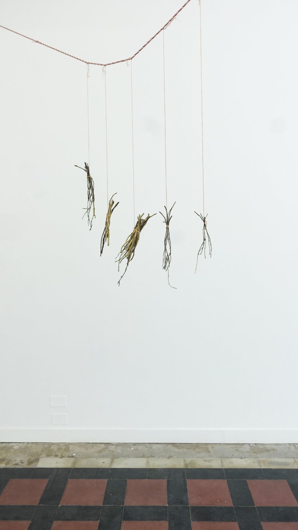 Kate Newby, Smaller than some bigger than most, 2019. Brass, silk thread, hand spun wool, lichen. Dimensions variable. 